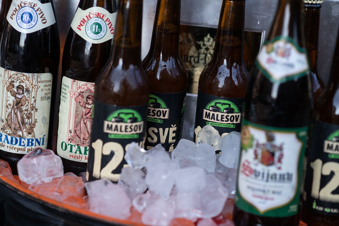Bottles of Czech craft beer chilled on ice at an event