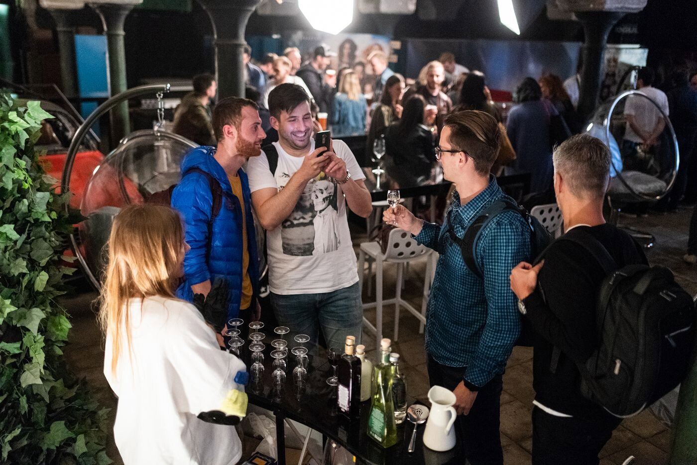 Guests talking and tasting drinks during an informal company gathering